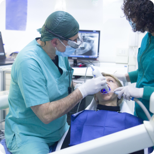 A dentist providing preventative care to a young patient.