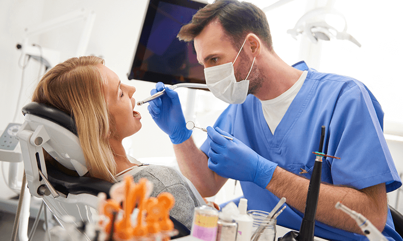 dentist examining mouth