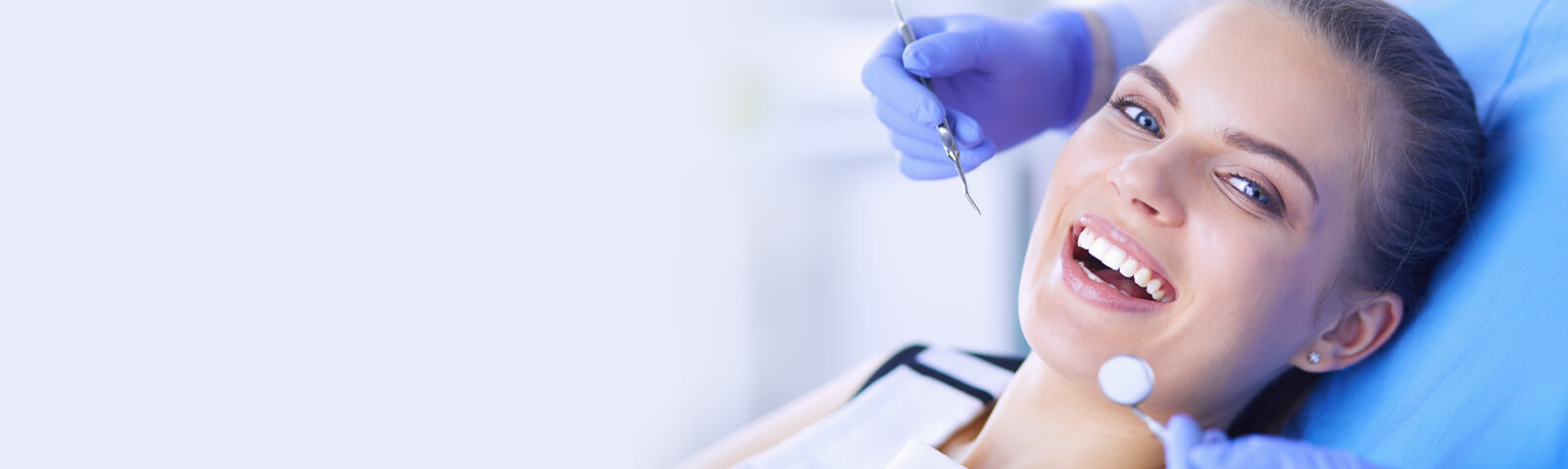 Smiling Woman Getting Teeth Cleaned at the Dentist