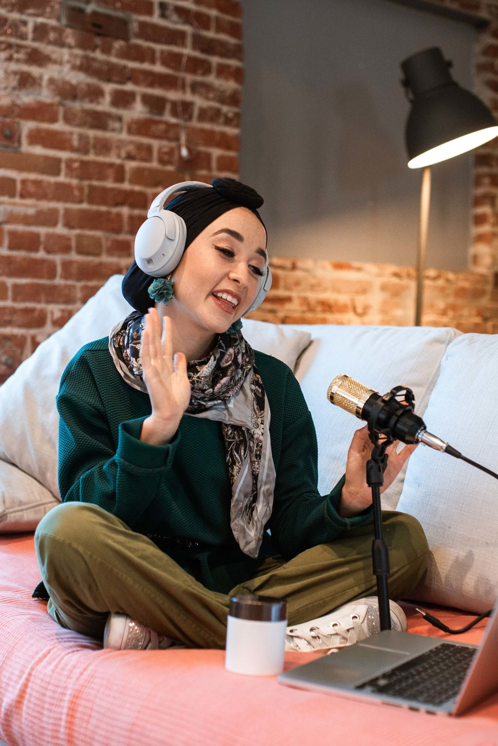 A woman with perfectly white teeth and a radiant smile talks into a microphone