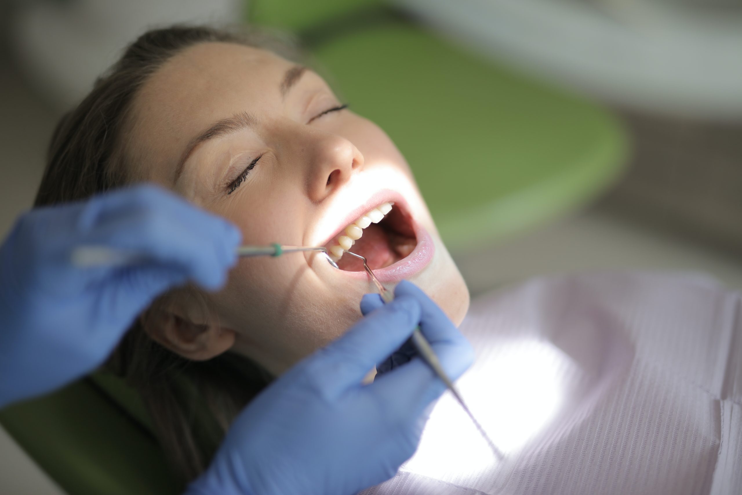 Woman undergoing deep dental cleaning procedure