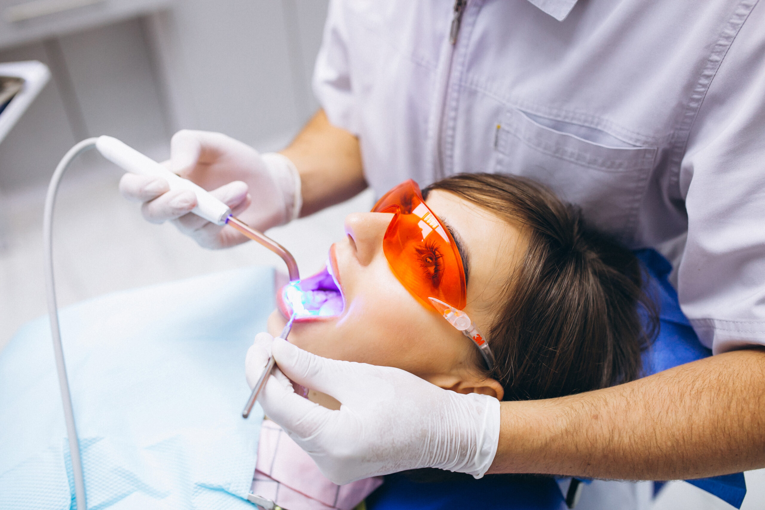 A woman receiving laser gum treatment